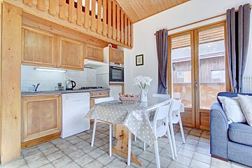 A kitchen with a table and chairs in it