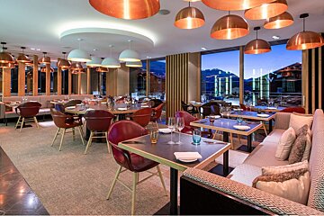 A restaurant with a lot of tables and chairs