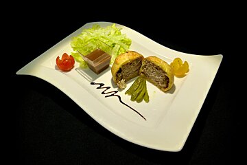 A white plate with a piece of food on it