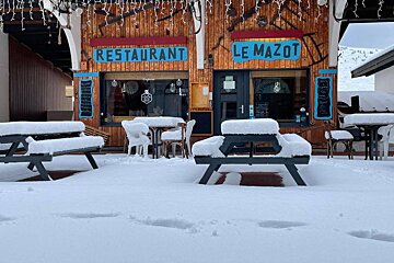 A restaurant called le mazot is covered in snow