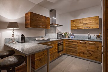 A kitchen with wooden cabinets and granite counter tops