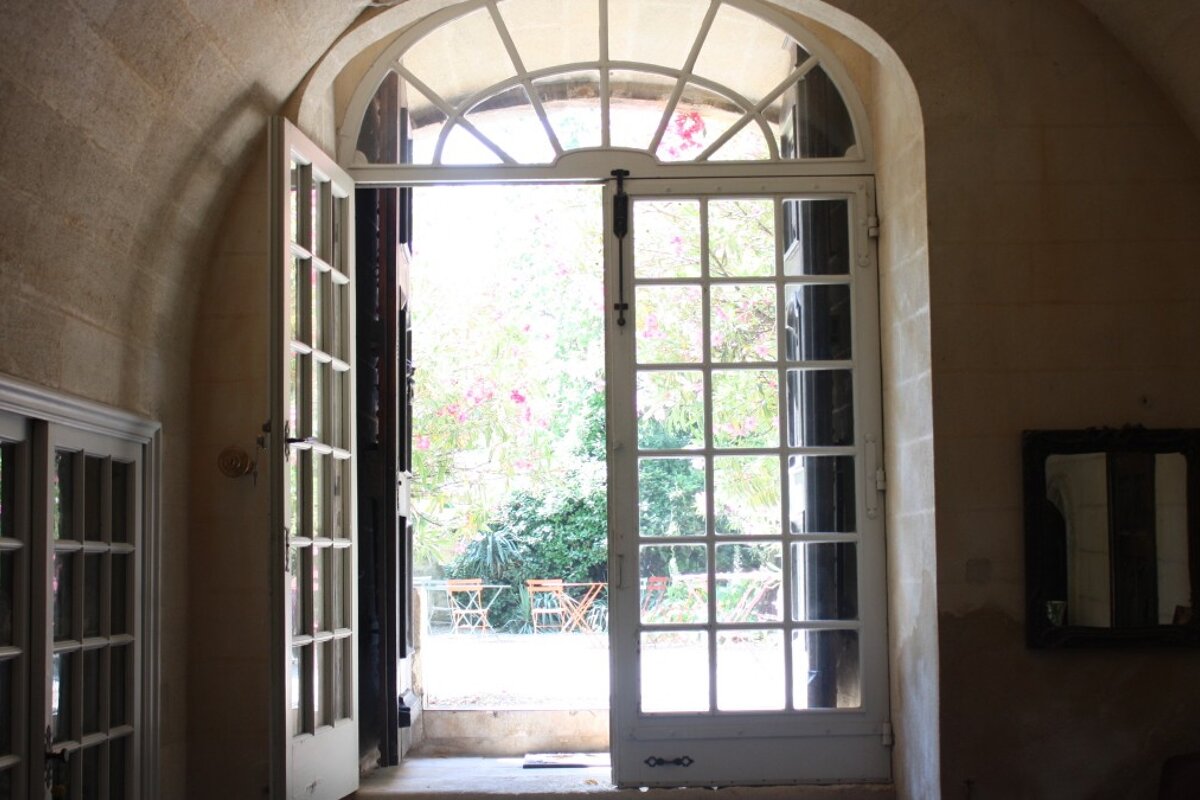 a large glass panelled door leading to a garden