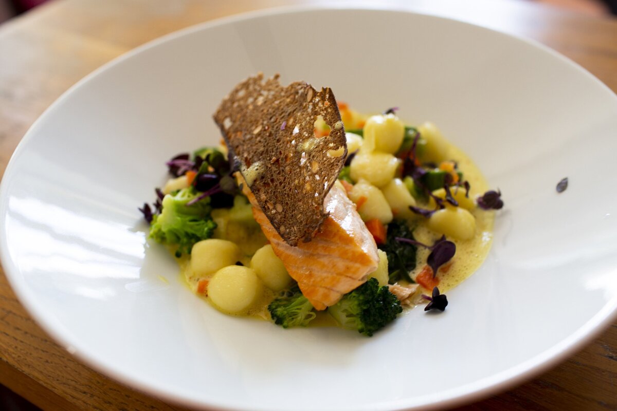 A plate of food with a piece of bread on top