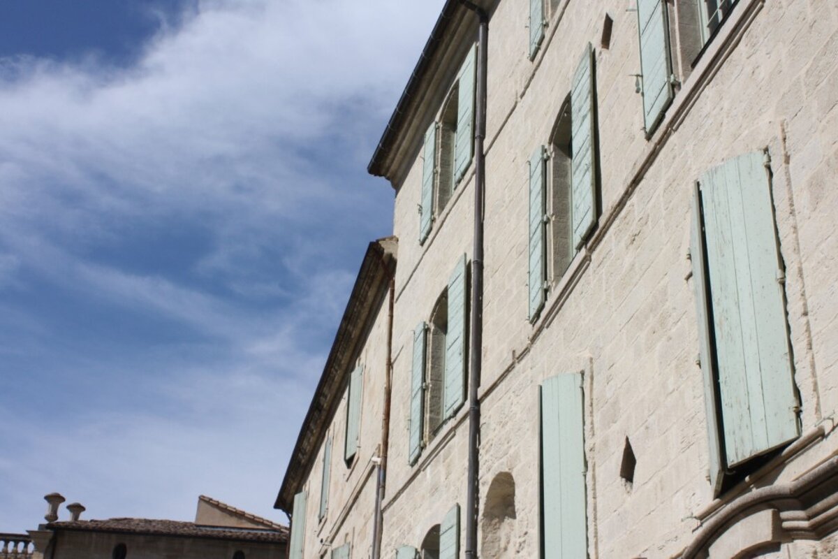 a building with duck egg blue shutters