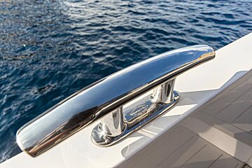 A stainless steel cleat on the side of a boat
