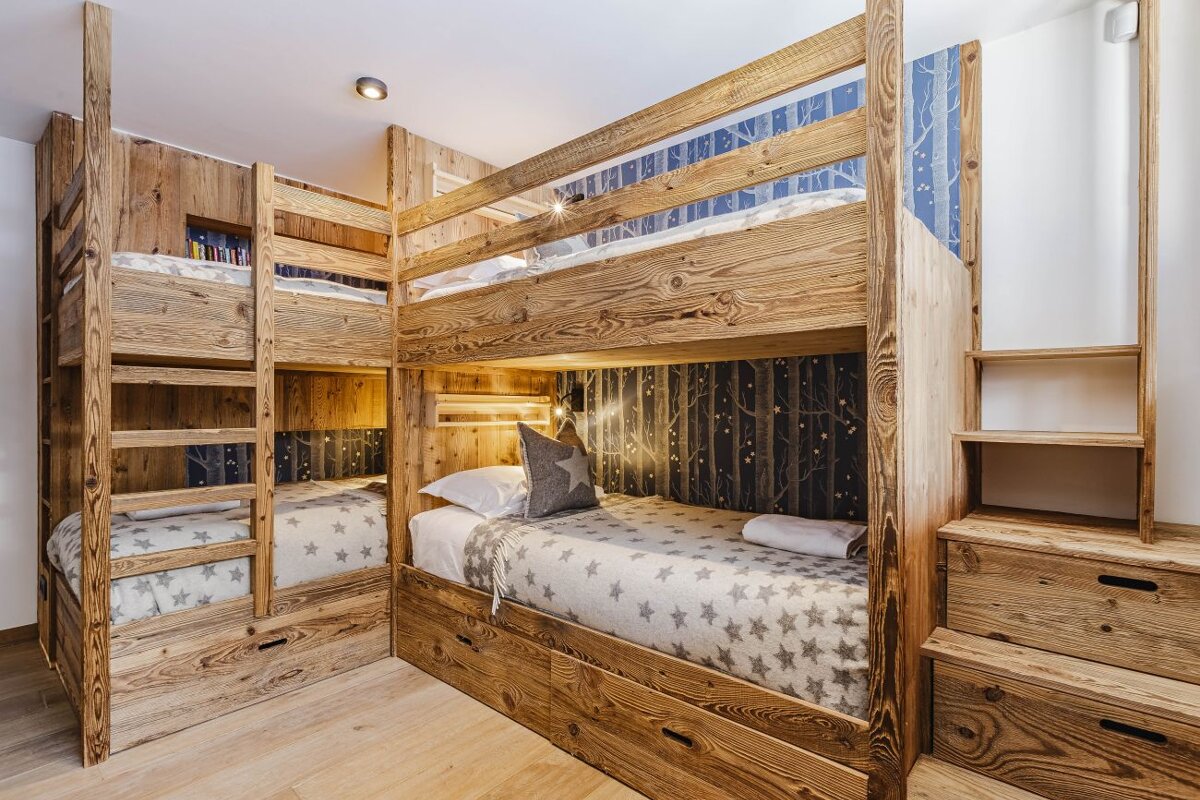 A bunk bed with a blanket with stars on it