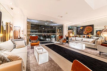 A living room with a couch and chairs and a sign that says ' nirvana ' on it