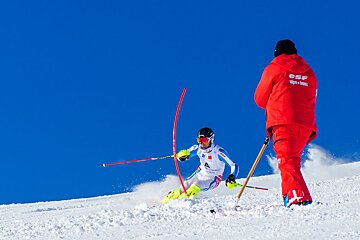 A man in a red jacket that says csf on it
