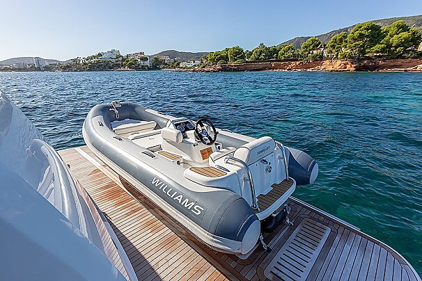 A williams boat sits on a wooden deck in the water