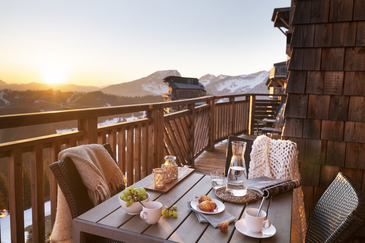 A table on a balcony with a view of the mountains