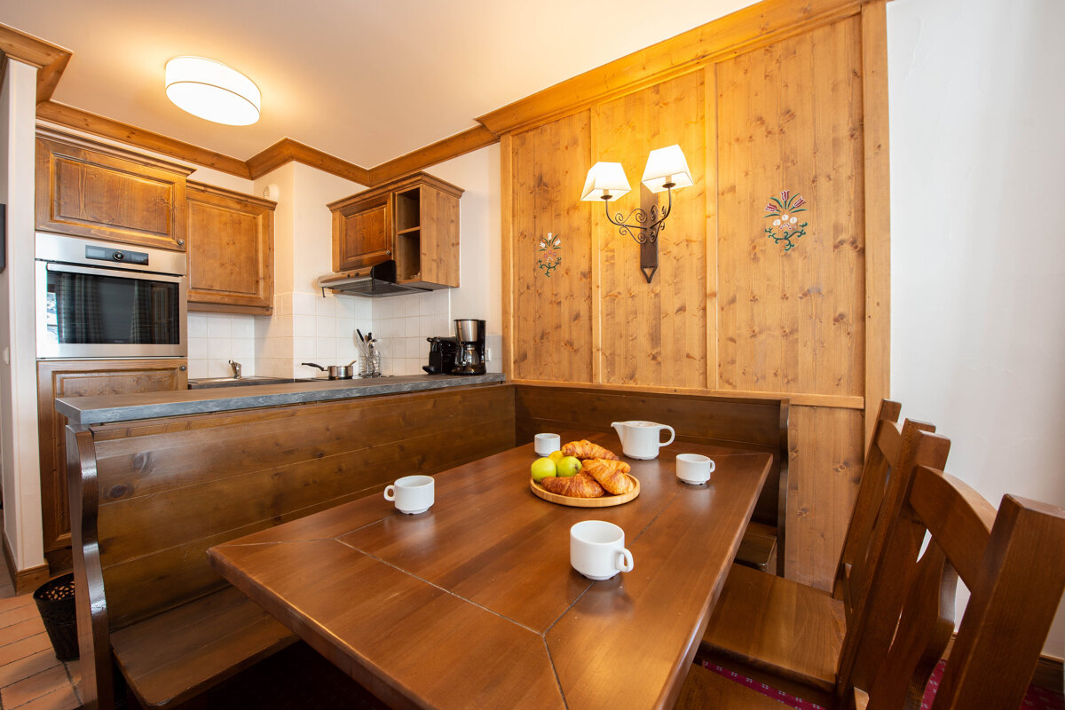 A wooden table with a tray of fruit on it