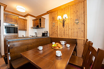 A wooden table with a tray of fruit on it