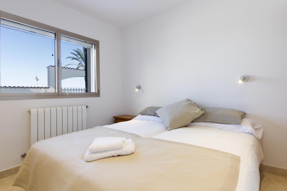 A bedroom with a bed a window and a radiator