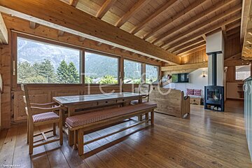 A living room with a table and chairs and a fireplace