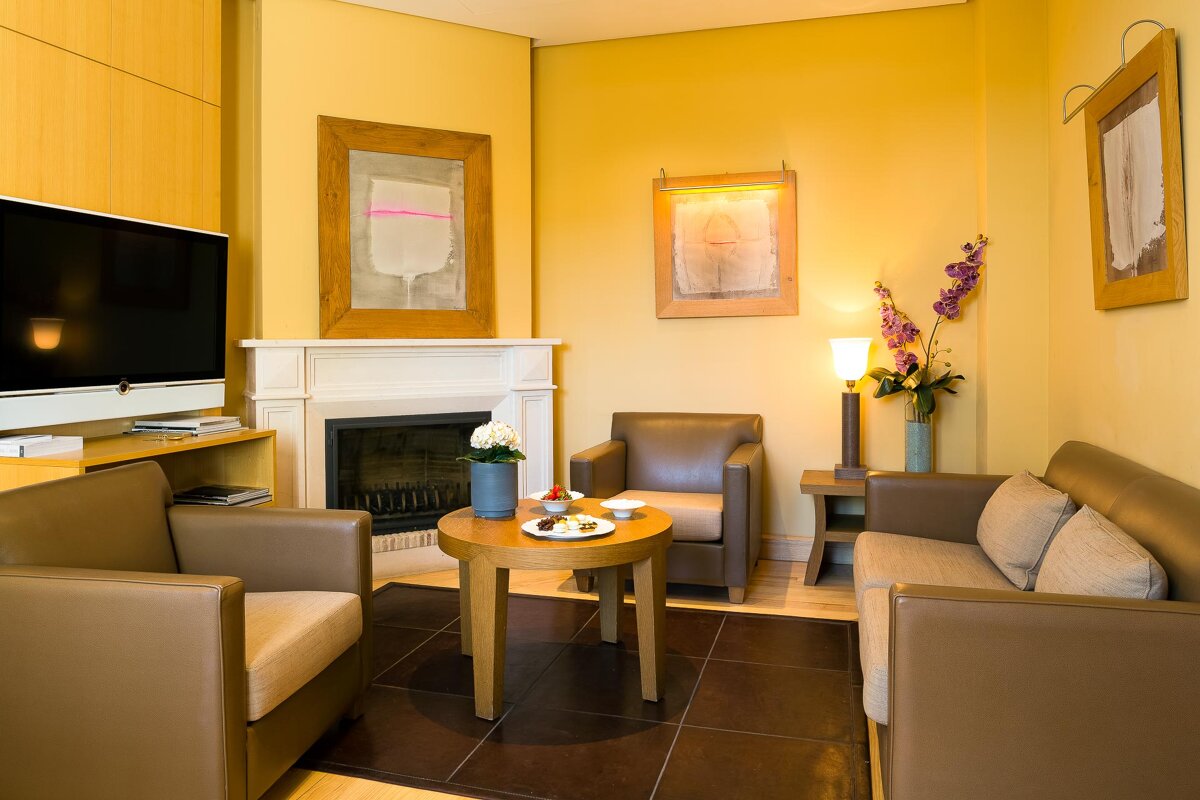 A living room with a fireplace and two chairs