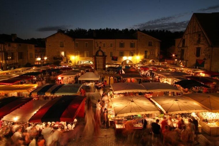 overlooking the stalls of a night market in eymet