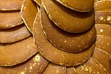 A pile of pancakes are stacked on top of each other
