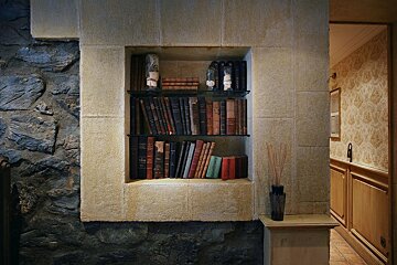 A bookshelf with a few books on it including one titled ' the bible '