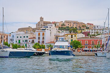 A boat in the water with a city in the background