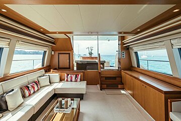 The inside of a boat with a couch and a coffee table