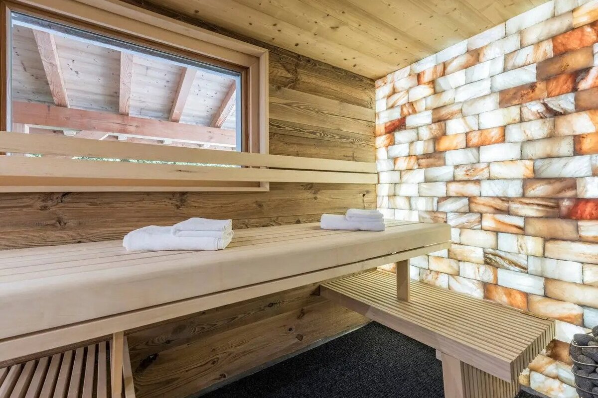 A wooden bench in a sauna with towels on it