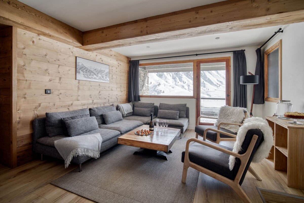 A living room with a couch a chair and a coffee table