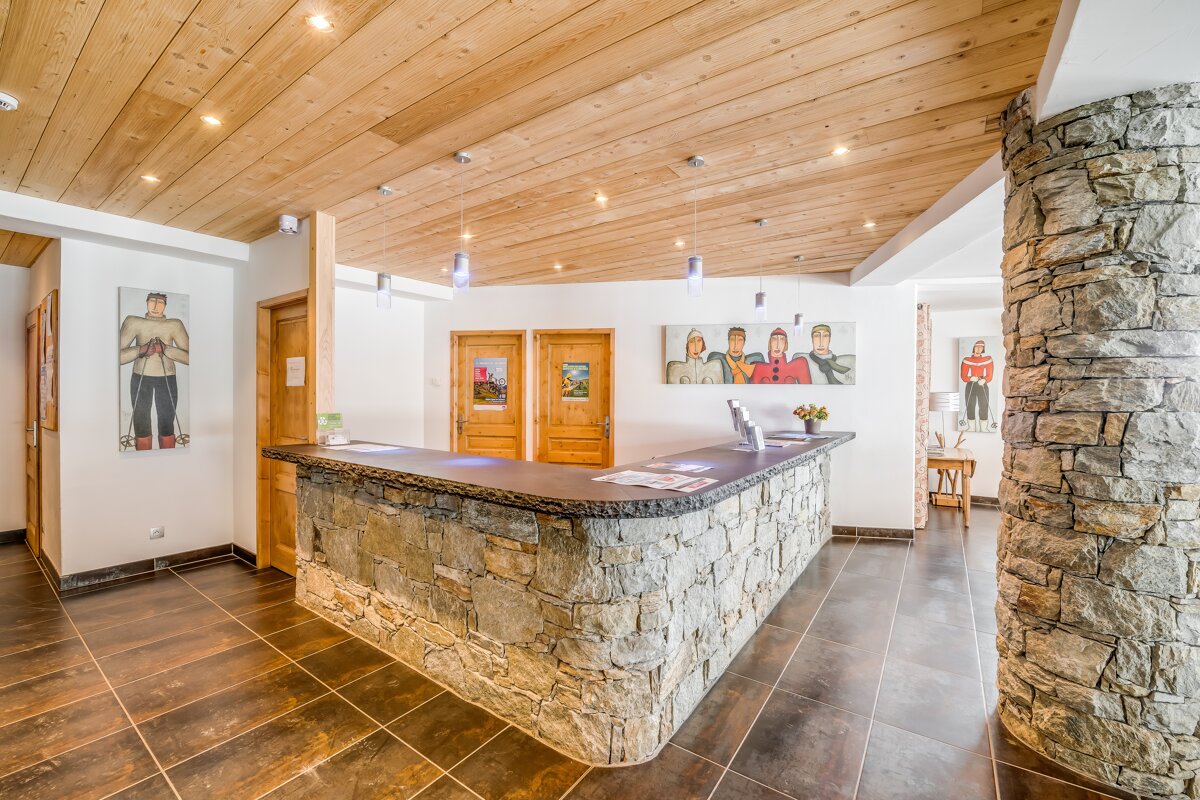 A stone counter in a room with paintings on the wall