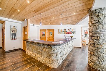 A stone counter in a room with paintings on the wall