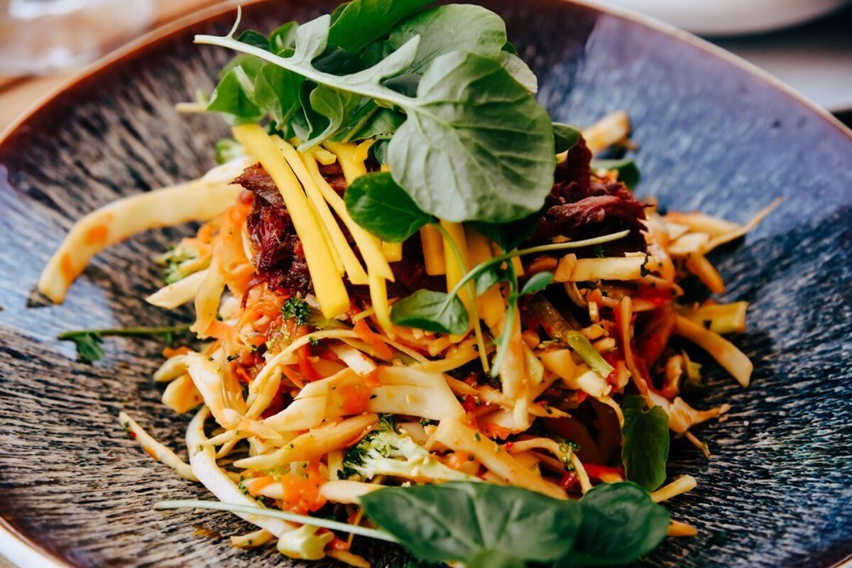A close up of a salad on a blue plate