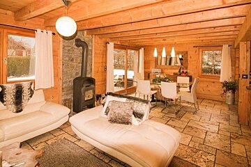 a lounge area in a chalet with fireplace