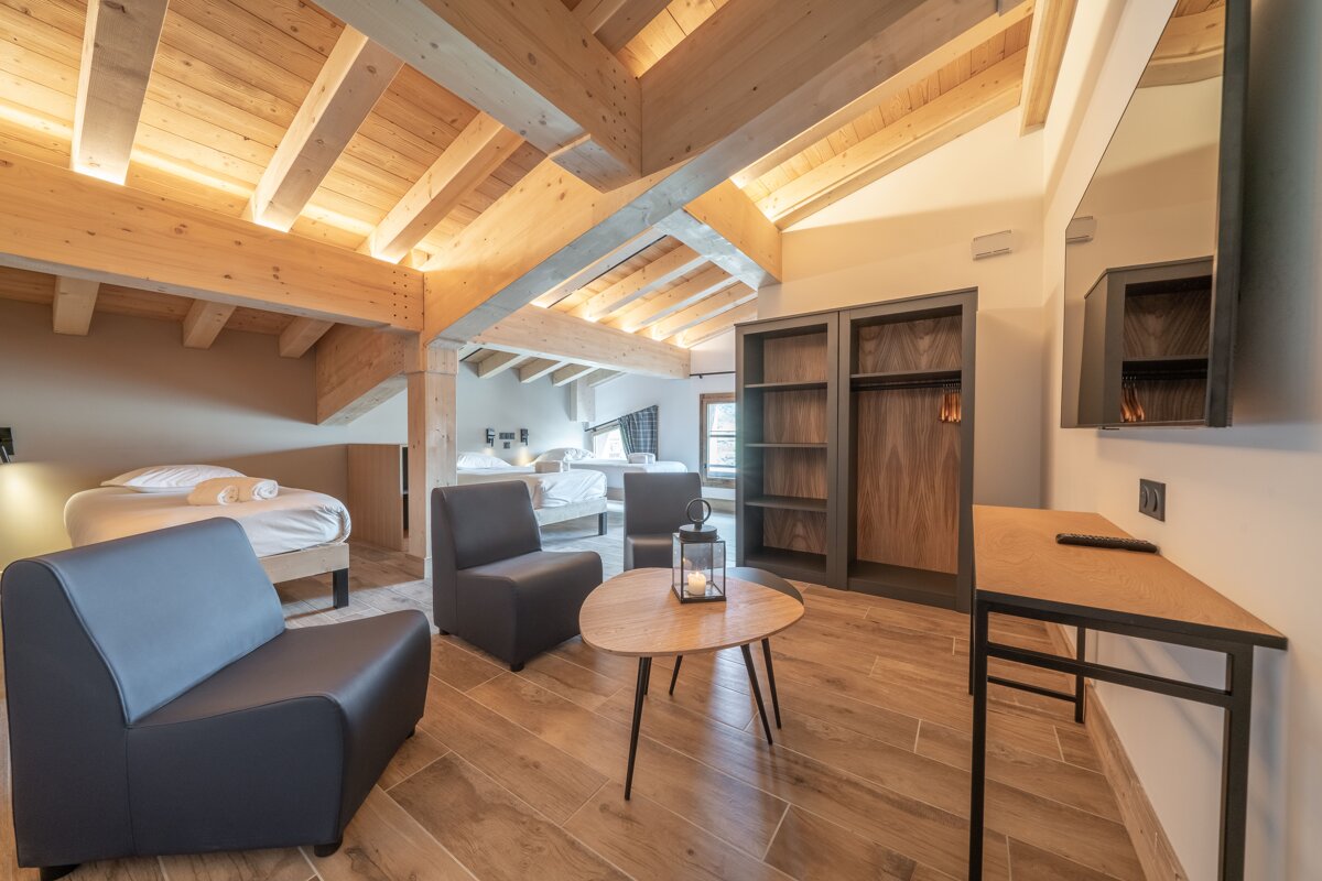 A room with a wooden ceiling and a table with a lantern on it
