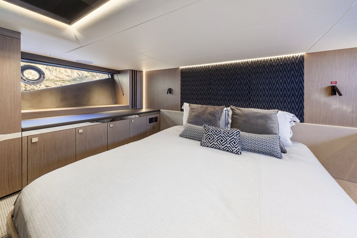 A bedroom with a bed and a fire extinguisher on the wall