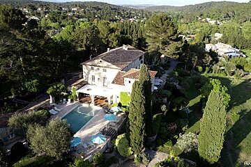 An aerial view of a large house with a swimming pool