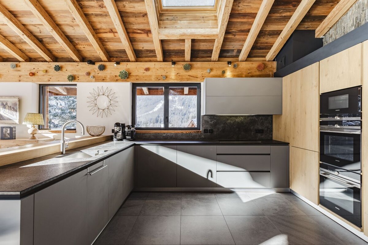 A kitchen with a skylight above the sink