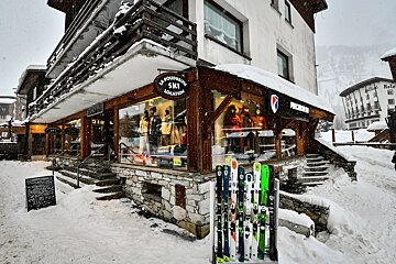 A snow-covered ski rental shop (