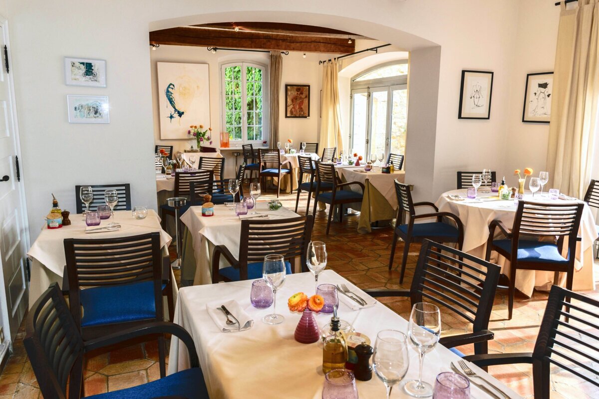 A restaurant filled with tables and chairs and glasses of wine