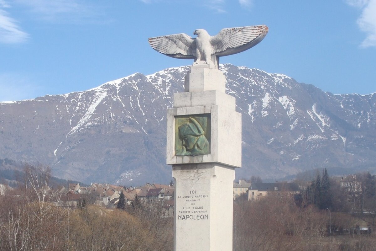 A statue of napoleon with a mountain in the background