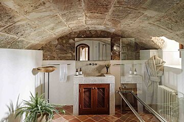 A bathroom with a stone ceiling and a sink