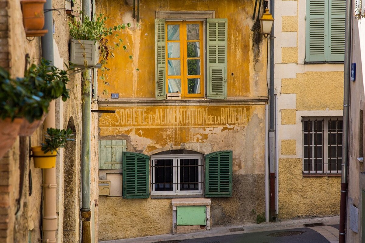 A yellow building with a sign that says societe d' alimentation de la riviera
