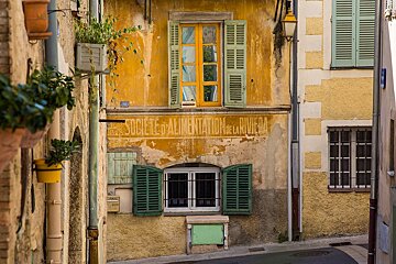 A yellow building with a sign that says societe d' alimentation de la riviera