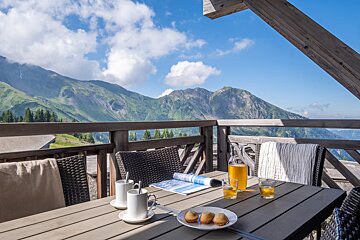 A table with a bottle of beer and a magazine on it