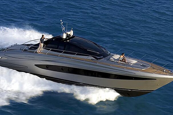 A large yacht is floating on top of a body of water