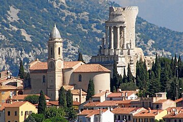 A small town with a church and a castle in the background