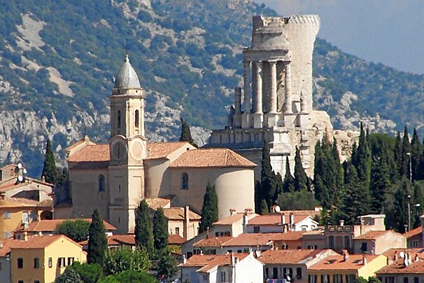 A small town with a church and a castle in the background