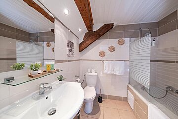 A bathroom with a toilet a sink and a bathtub