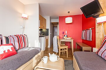 A living room with a couch a table and a television
