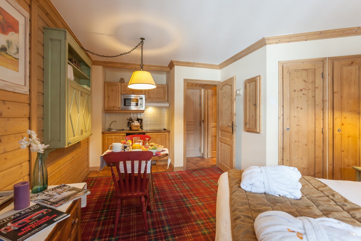 A room with a table and chairs and a magazine that says ' automobile ' on it