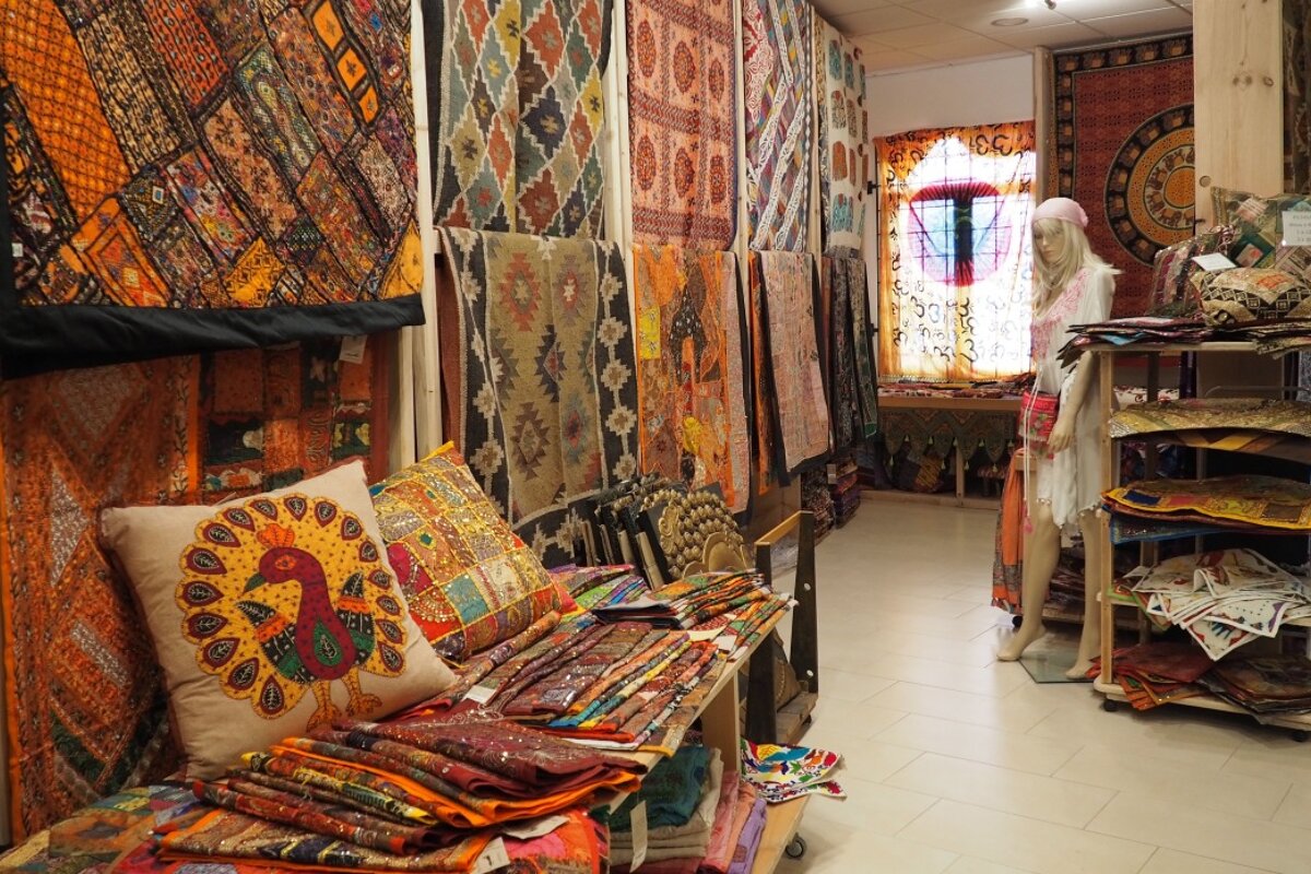 a shop with inidan covers & hangings in santa gertrudis ibiza