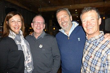 four people in a bar