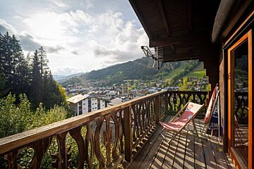 A balcony with chairs and a pepsi sign